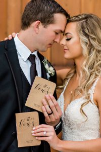 bride and groom with vow books at grace barn in fowler ca