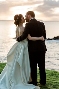 bride and groom watching the sunset at ponomakena sanctuary maui wedding