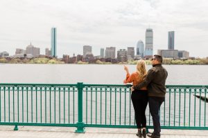 engaged couple enjoying the Boston Skyline