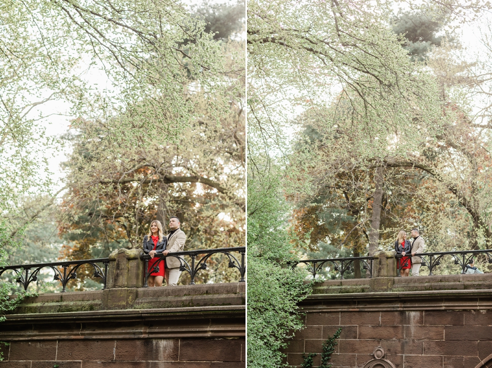 engaged couple standing on trefoil arch central park new york city