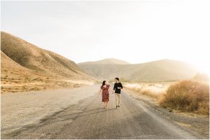 happy couple running on a road, asl engagement session